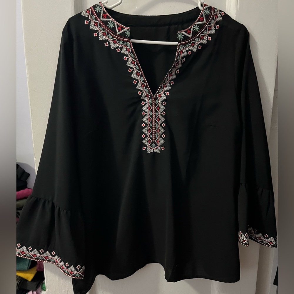 Black blouse with colorful embroidery detailing and flare sleeves, Size Large.